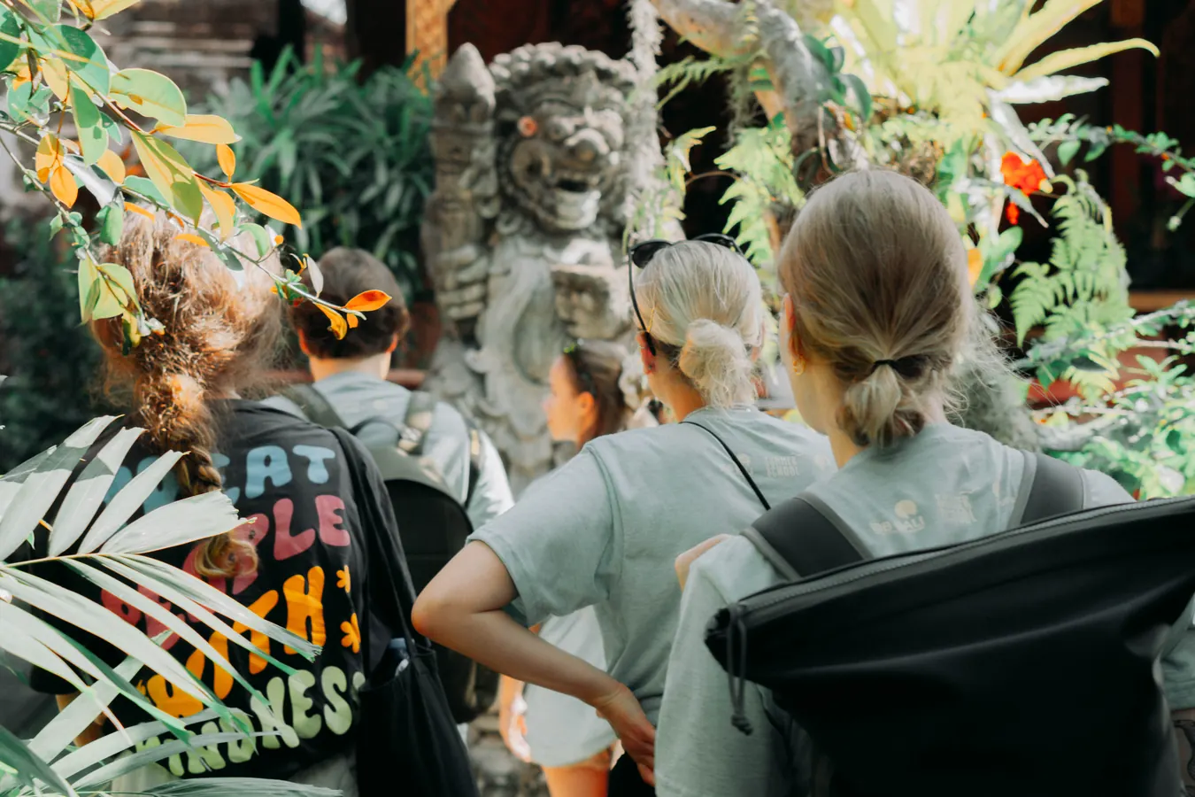 A StudyInBali group walking into a temple garden in Bali